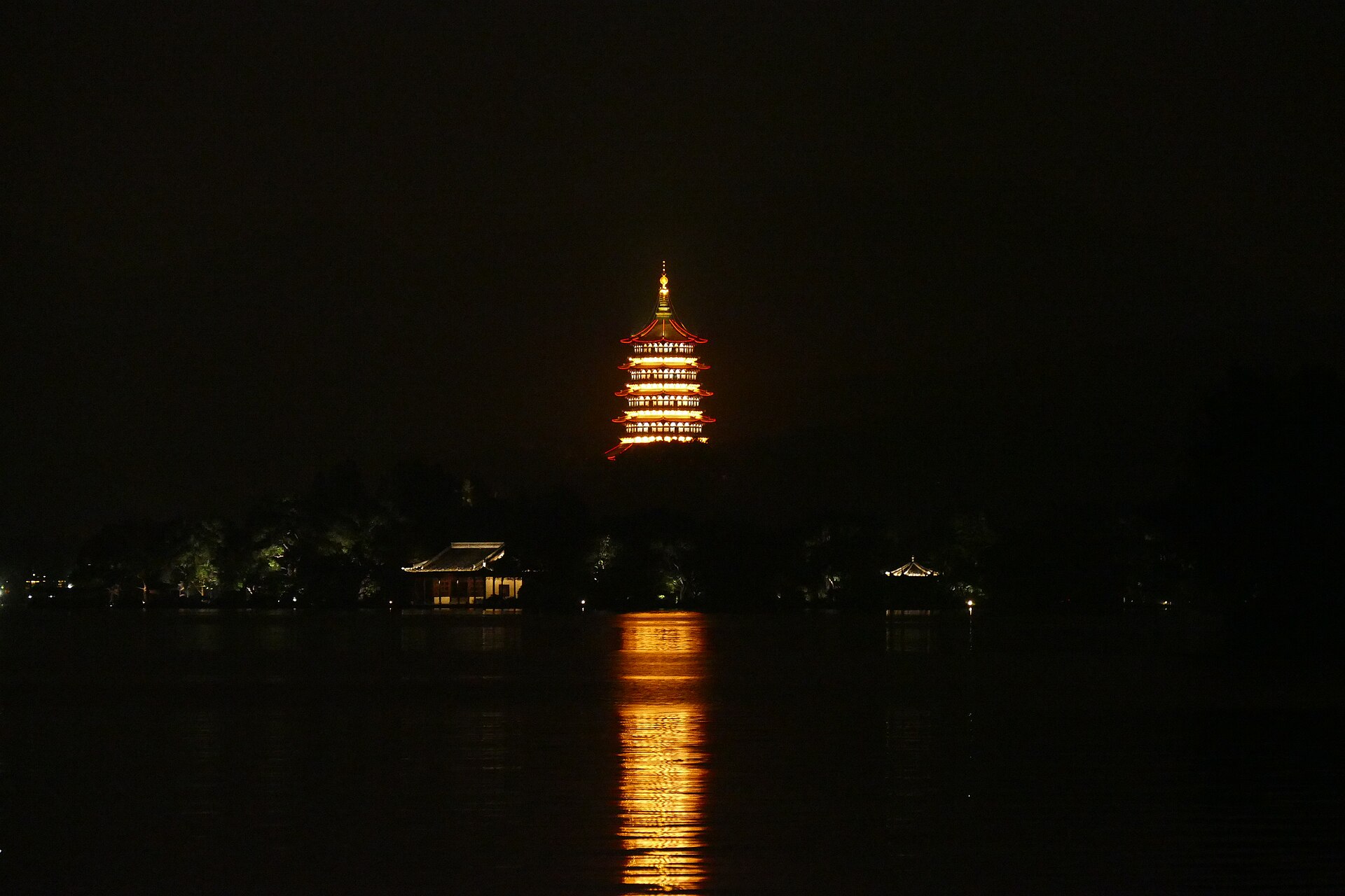 Leifeng Pagoda lit up at night over West Lake, Hangzhou
